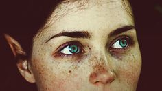 a woman with freckled hair and blue eyes