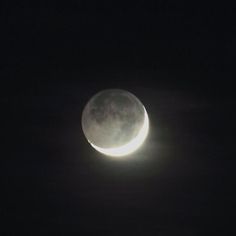 the moon is visible in the dark sky