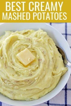 a white bowl filled with mashed potatoes and butter on top of a checkered table cloth