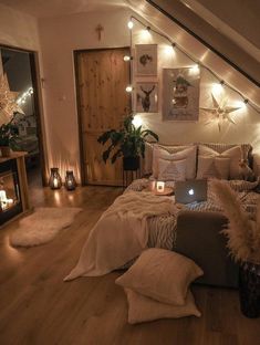 a bedroom with lights on the wall and a bed in the middle, surrounded by pillows