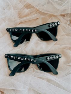 two sunglasses with the words ring bearer on them