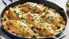 chicken and rice in a skillet with vegetables