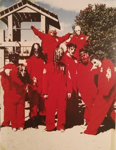 group of people in red costumes standing next to each other