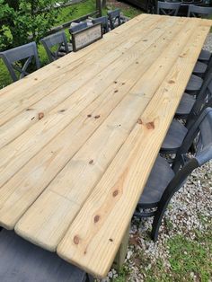 a large wooden table sitting on top of a grass covered field