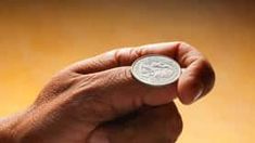 a person holding a coin in their hand