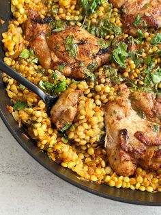 a skillet filled with chicken and corn