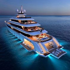 a large white boat floating on top of the ocean at night with lots of lights