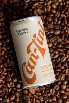 a can of coffee sitting on top of a pile of coffee beans with the word costa written in spanish