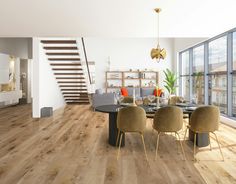 a modern living room with wood floors and large windows