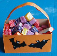 a paper bag filled with candy and bats