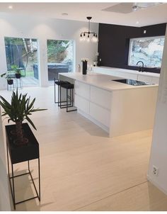 an open kitchen and living room with white walls