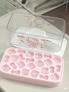 a hello kitty ice tray and an empty plastic container