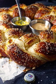 the bread has been cut into pieces and is being served with dipping sauces on it