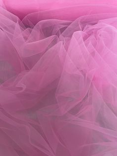 pink tulle fabric close up on white background