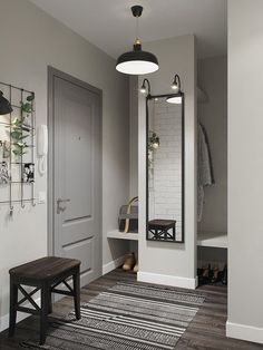 a hallway with a bench, mirror and coat rack on the wall next to it