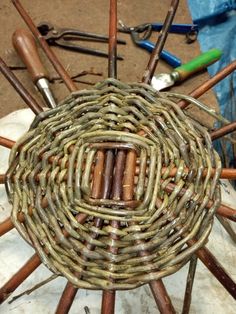 a wicker basket with many different tools around it