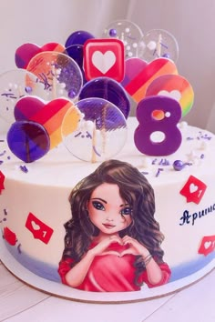 a birthday cake with an image of a woman on it and other decorations around the cake