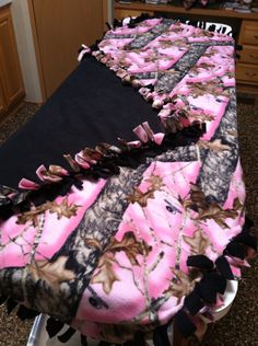 a pink and black camo blanket on top of a table