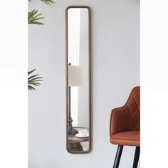 a large mirror hanging on the wall next to a chair