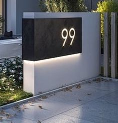 a large black and white sign with the number 99 on it in front of a house