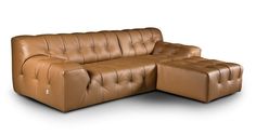 a brown leather couch sitting on top of a white floor