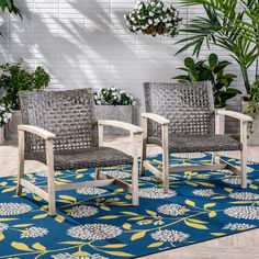 two chairs sitting on top of a blue rug