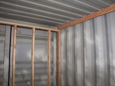 the inside of a room that is being built with metal walls and insulation in place