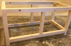 an unfinished bed frame sitting on the floor