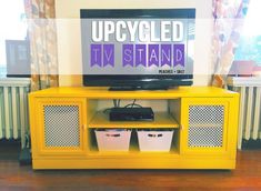 a yellow tv stand with baskets underneath it and the words upcycled fix stand on top