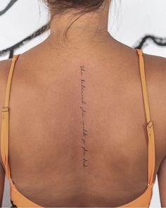 the back of a woman's neck with an inscription on it