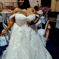 a woman in a wedding dress posing for the camera