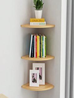 three wooden shelves with books and pictures on them in a corner next to a window