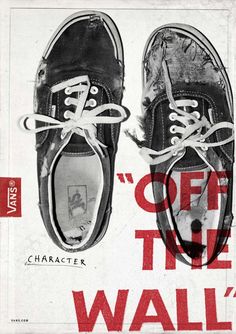 a pair of black shoes with white laces advertises vans off the wall