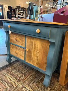 an old dresser is painted blue and brown