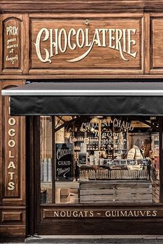 a store front with the words chocolaterie written on it's windows and an awning