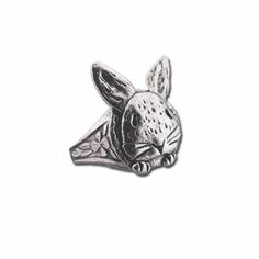 a metal pin with a rabbit head on it