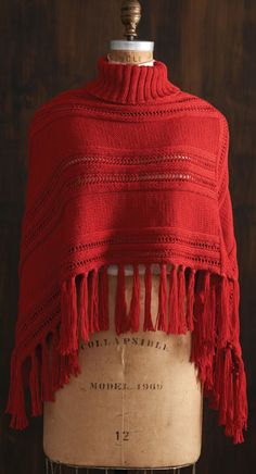 a red shawl draped over a mannequin's dummy with an inscription on it