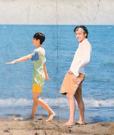 two boys are playing on the beach