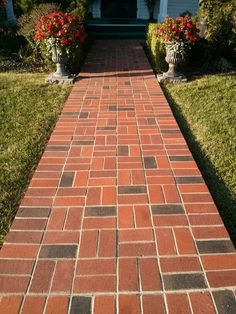 a red brick walkway leading to a white house