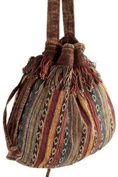 Step into bohemian bliss with our Striped Tibetan Drawstring Slings.  Carry your essentials in artful elegance and make a statement wherever you go.Hand loomed Tibetan Cotton, a fringe accent and metal eyelets to adjust its strap. Inside, the main compartment has a black cotton lining. A trendy tibetan bag strong and sturdy, its colors inspire whimsical delight. Measurements Dimensions: 13" H x 14" W Strap Width :  1.5 " W Adjustable Strap Length : 14 -23" L                                                                                       A beautiful and rare handmade creation by Earth Divas, your purchase supports women artisans in Nepal. You will notice our creations are so well made Each piece has its particular flair to it, handmade, hand embroidered, hand woven.  100% sustainable Hippie Love, Women Artisans, Women Supporting Women, Cross Body Handbags, Black Cotton, Diva, Hand Embroidered, Purses And Handbags, Hand Weaving