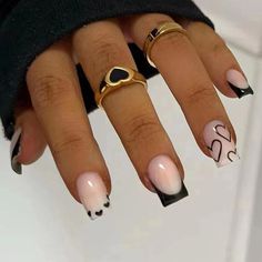 a woman's nails with black and white designs on them