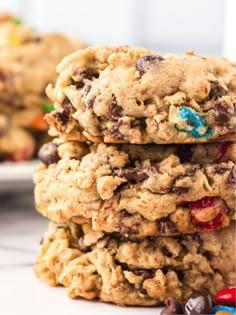 three cookies stacked on top of each other with m & m candy in the middle