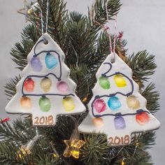 two christmas ornaments hanging from a tree with decorations on it's top and bottom