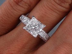 a woman's engagement ring with a princess cut diamond