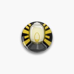 a yellow and black button with a light bulb on it