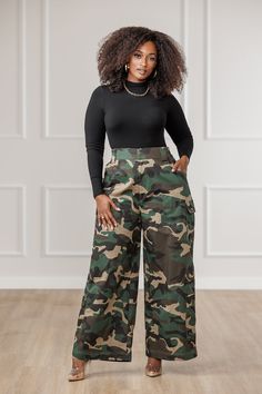 A J. Brooks Exclusive! Get ready to blend in and stand out with our Kalea Wide Cargo Pants. These camouflage, high-waisted palazzo pants offer comfort and style in one. Perfect for any adventure, these pants will take you from practical to fashionable with ease. Description: High rise. Snug fit in the waist, relaxed fit along hip and leg. Front zipper closure, elastic on side waistband, functional pockets, palazzo style pants. No stretch, printed - 95% cotton, 5% spandex Inseam: 28" approx. Wais Camo Wide Leg Pants Outfit, Camouflage Wide Leg Pants With Pockets, Wide Leg Camouflage Cargo Pants, What To Wear With Camo Pants, Olive Cargo Pants Outfit, Trendy Camouflage Wide-leg Pants, Camouflage Pants Outfit, Camouflage Military Wide Leg Cargo Jeans, Trendy Full-length Camouflage Cargo Pants