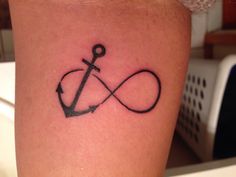 an anchor tattoo on the leg of a woman's lower arm, which is drawn in black ink