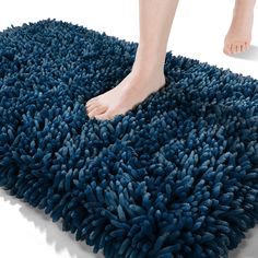 a person standing on top of a blue rug