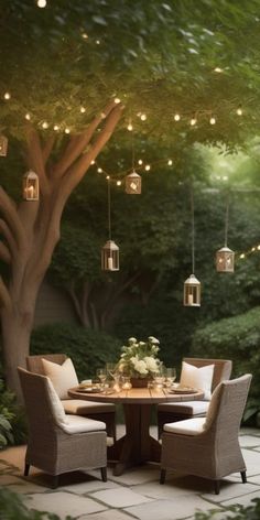 an outdoor dining table with chairs and lights hanging from the ceiling above it, surrounded by greenery