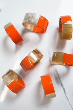 orange and gold rings on a white surface